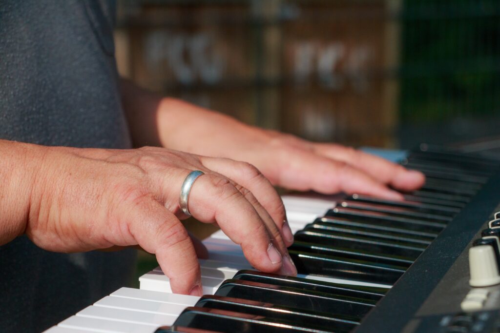 man playing a used piano for sale in new jersey